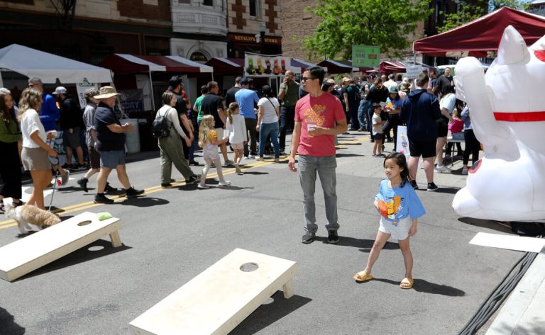 a game of cornhole in a closed street at the festival